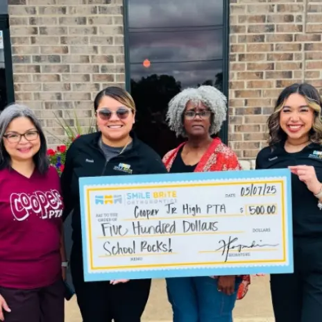 people holding a large check