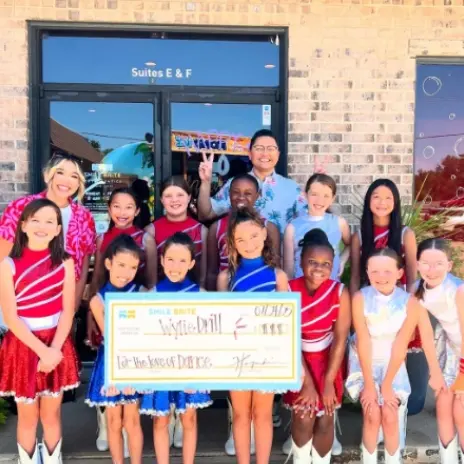 kids holding large check