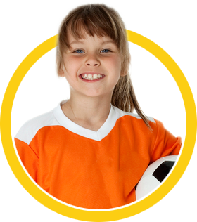girl smiling holding a soccer ball