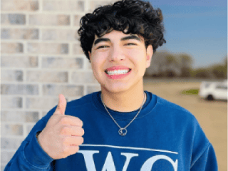 teen smiling with thumbs up